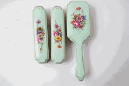 A Worcester porcelain mounted set of three dressing table brushes, hand painted flower decoration,