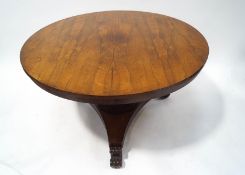 A Victorian rosewood breakfast table with waisted cylindrical pedestal on triform base on scroll