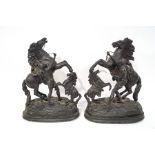 A pair of Spelter figures of Marley horses, each on oval ebonised bases with turned ball feet,