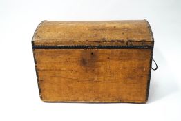A pine trunk with dome top and iron handles, formerly leather covered,