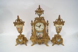 A 20th century cast brass clock garniture with painted porcelain panels on a pale yellow ground,