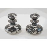 A pair of silver overlaid glass scent bottles and stoppers,