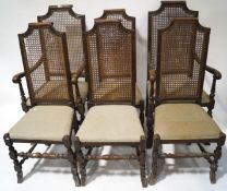 A set of six 17th century style oak chairs with caned backs and drop in seats,