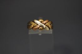 A 9 carat three coloured gold ring, of knot design, finger size O1/2, 3.