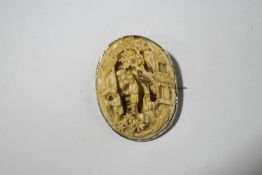 A Chinese carved ivory brooch, circa 1930, carved with figures in a garden by a building, 3.