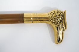 A walking stick with polished brass Griffin's head handle.