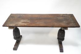 A 17th century and later oak refectory table with double plank top on two carved baluster supports