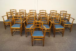 A set of seventeen oak chairs, each with rail backs, shaped arms,