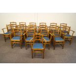 A set of seventeen oak chairs, each with rail backs, shaped arms,