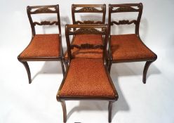 A set of four William IV mahogany carved bat back dining chairs,