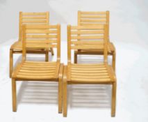 A set of four beech stacking chairs with bent wood frames,