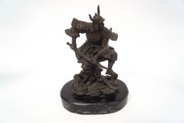 A modern bronze figure of a Samurai Warrior, on a black marble base,