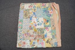 A 1930's patchwork quilt converted to a door curtain, with blanket back,