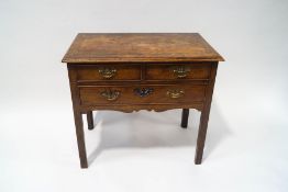 A George III mahogany low boy with cross banded top above two short and one long drawer with square