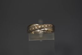 A 9ct white gold seven stone diamond ring, set across the finger,