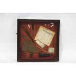 Various button hooks, buckles, advertisements, buttons and other items, within a mahogany box frame,