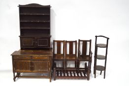 A quantity of oak dolls furniture comprising a sideboard, a dresser, a dining room table,