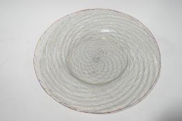 An Italian glass plate, spirally moulded with spiral blue,