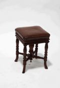 A Victorian mahogany adjustable piano stool, with leather seat,
