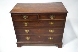 A George III mahogany chest of two short over three long drawers, upon bracket feet,