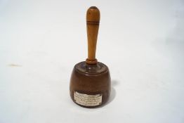 A treen mallet with applied white metal plaque,