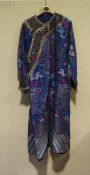A 20th century Chinese robe, the mixed woven fabric decorated with dragons,