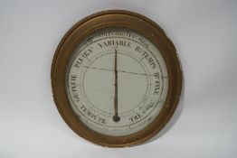 A French oval barometer within an 18th century gilt frame,