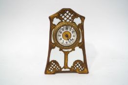 An Ansonia Art Nouveau clock, porcelain body with pierced brass metal decoration,