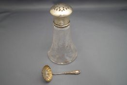 A silver mounted glass sugar castor; and a small silver sifting spoon; 334 g (1.