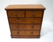 A Victorian mahogany chest of two short and three long drawers with turned handles on bun feet,