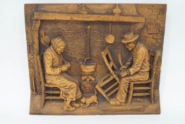 A carved oak plaque by C.A.