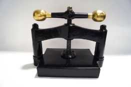 A Victorian cast iron and brass book press,