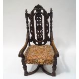 A Victorian oak elbow chair with carved and pierced back,