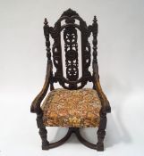 A Victorian oak elbow chair with carved and pierced back,