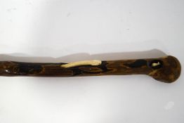 An unusual 19th century wooden walking stick inset with carved ivory snake chasing a mouse