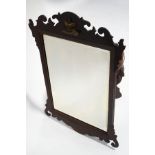 A George II style wall mirror, the mahogany fret frame with applied gilt coronet on a cushion,