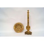 A Middle Eastern brass hookah pipe, partially converted to a table lamp, on a scroll and shell base,