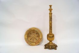 A Middle Eastern brass hookah pipe, partially converted to a table lamp, on a scroll and shell base,