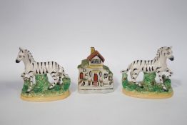 A 19th century Pearlware Staffordshire money box in the form of a house, 10.