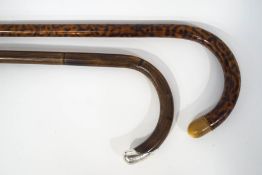 Two walking sticks, one with silver tip London 1907,