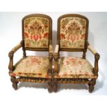 A pair of 19th century continental elbow chairs, each with carved mahogany frames,