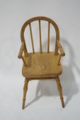 A miniature stick back childs chair with solid ash seat, on turned legs linked by an H stretcher,