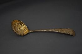 A George III silver sifting spoon, by Eley, Fearn & Chawner, later decorated, 15.5 cm long, 45 g (1.