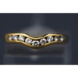 A nine stone diamond ring, the channel set brilliant cuts totalling approximately 0.