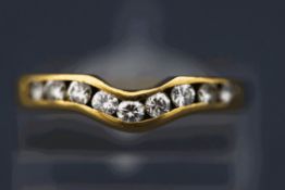 A nine stone diamond ring, the channel set brilliant cuts totalling approximately 0.