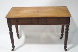 A Victorian mahogany side table with two drawers, on turned and reeded legs,