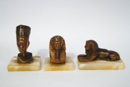 Three Egyptian patinated Spelter figures, each mounted on soapstone bases, highest 13.5cm high.
