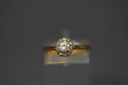 A diamond cluster ring, the central brilliant cut of approximately 0.