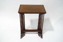 A nest of four mahogany tables, each with carved beaded top on turned legs and splayed feet, 69.