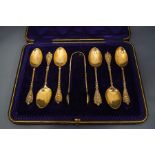 A cased set of six silver gilt tea spoons and sugar tongs, by Holland, Aldwinkle & Slater,